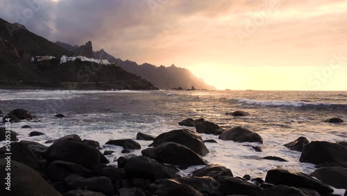 Ocean waves crash on rocks in sunset light Playa Benijo beach, Tenerife, Canary photo