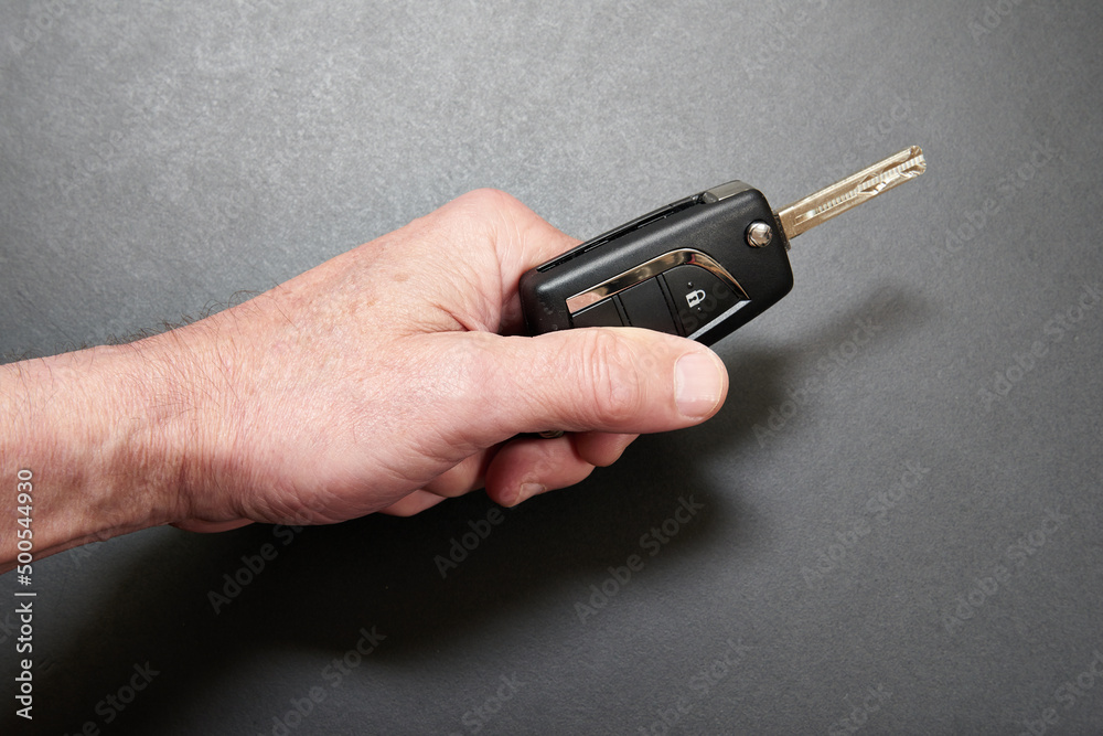 Man's hand holding a Hybrid key car Man's hand holding a Hybrid key car