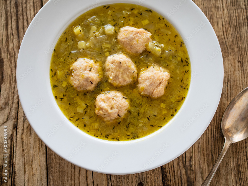 Boiled pork meatballs in onion soup on wooden table
Boiled pork meatballs in onion soup on wooden table