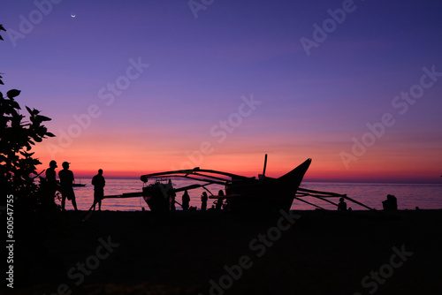 Boracay, Philippines, Jan 27, 2020: Traditional boats with tourists on the sea against the background of the setting sun