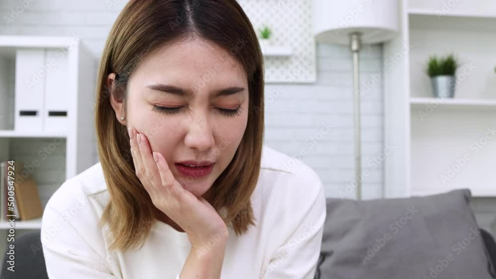 Asian woman suffering from toothache, Cavities or tooth decay concept Asian woman suffering from toothache, Cavities or tooth decay concept
