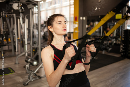 young girl in the gym, crossfit workout, athletic body, cardio workout. 