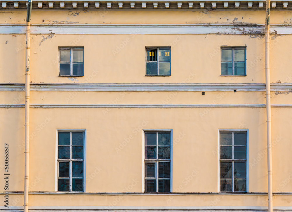 Several windows in a row on the facade of the urban historic apartment building front view, Saint Petersburg, Russia
