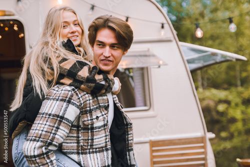 Young just married couple traveling in camper,house on wheels,trailer,motor home.Love romantic road travel,freedom life.Campsite overnight in van.Wanderlust vacation,weekend. Girl,guy,happy adventure © velirina
