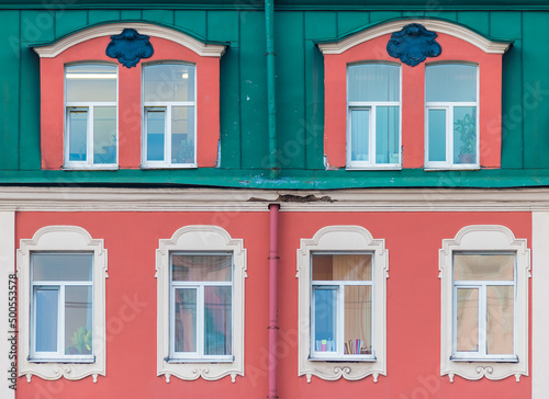 Several windows in a row on the facade of the urban historic apartment building front view, Saint Petersburg, Russia
