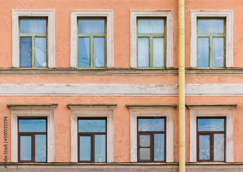 Several windows in a row on the facade of the urban historic apartment building front view, Saint Petersburg, Russia  © dr_verner