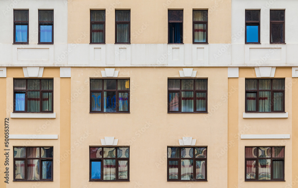 Many windows in a row on the facade of the modern urban apartment building front view, Krasnaya Polyana, Sochi, Krasnodar Krai, Russia
