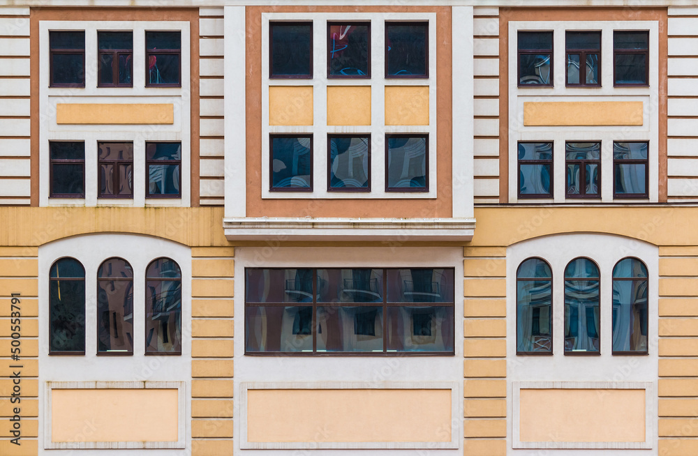 Many windows in a row on the facade of the modern urban apartment building front view, Krasnaya Polyana, Sochi, Krasnodar Krai, Russia
