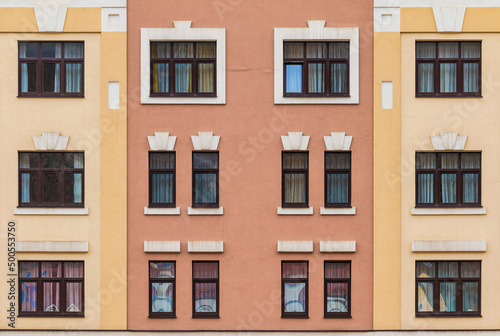 Many windows in a row on the facade of the modern urban apartment building front view, Krasnaya Polyana, Sochi, Krasnodar Krai, Russia 