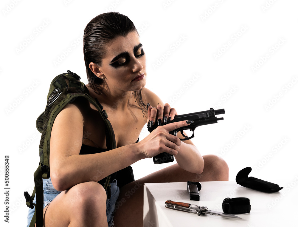 Dangerous female killer with a gun. Beautiful shapely woman. Specific makeup Dangerous female killer with a gun. Beautiful shapely woman. Specific makeup