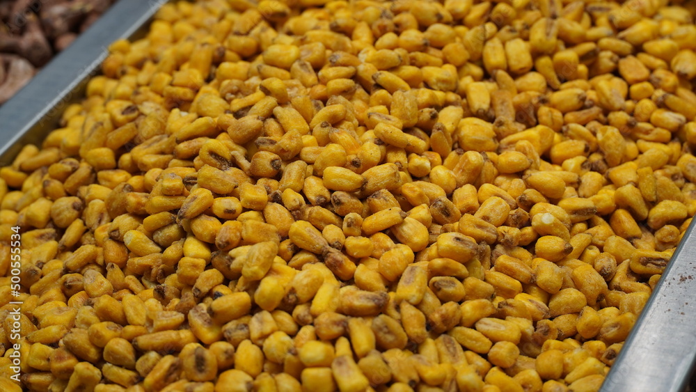 Roasted salted corn nuts for sale in local market. Beer snack, dry corn with spices