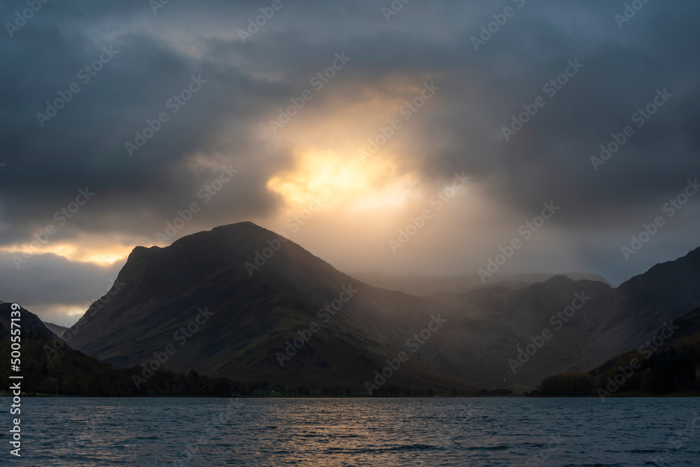 Epic Autumn sunrise landscape image of Buttermere in Lake District with dramatic stormy sky Epic Autumn sunrise landscape image of Buttermere in Lake District with dramatic stormy sky