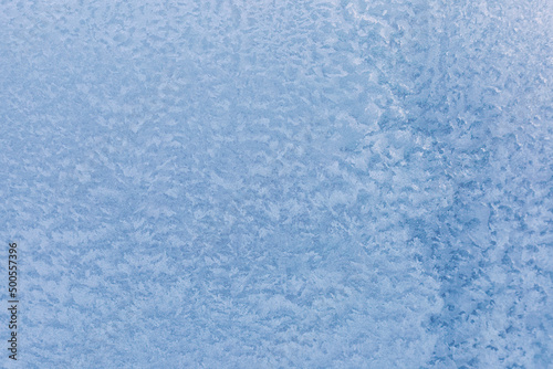 Frosty patterns, icy window. Winter background, selective focus, close-up.