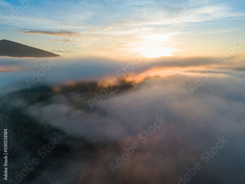 Foggy summer morning in the Ukrainian Carpathians. Aerial drone view. © Sergey