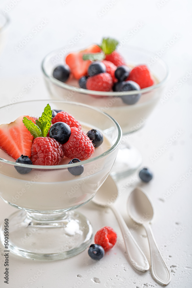 Cold and delicious Panna Cotta served in glass with berries. Cold and delicious Panna Cotta served in glass with berries.