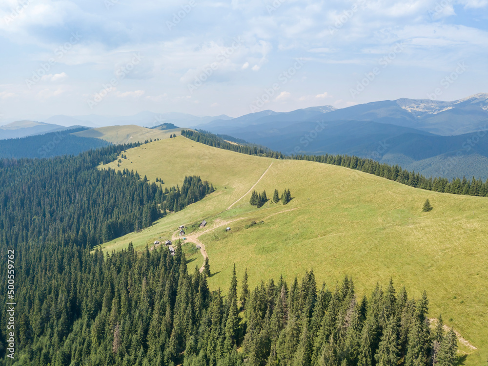 Green mountains of Ukrainian Carpathians in summer. Sunny day, rare clouds. Aerial drone view. Green mountains of Ukrainian Carpathians in summer. Sunny day, rare clouds. Aerial drone view.