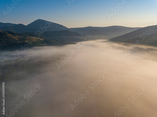 Morning fog in the Ukrainian Carpathians. Aerial drone view. © Sergey