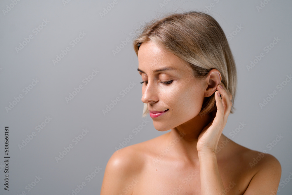 Natural beauty. Blonde woman with healthy skin. No makeup. Grey background. Natural beauty. Blonde woman with healthy skin. No makeup. Grey background.