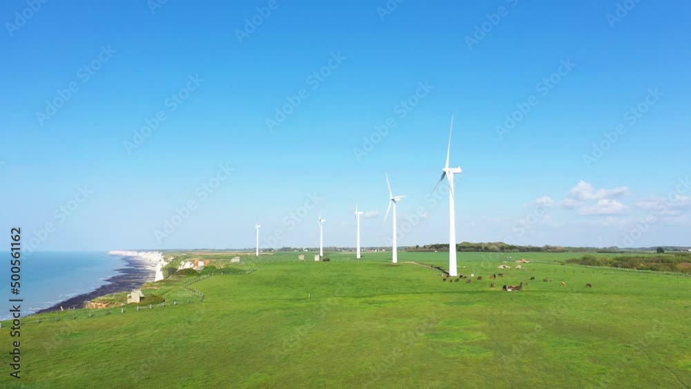 Wind turbines above the city of Fecamp above the cliffs , Europe, France, Normandy, Seine Maritime, in summer, on a sunny day. Wind turbines above the city of Fecamp above the cliffs , Europe, France, Normandy, Seine Maritime, in summer, on a sunny day.