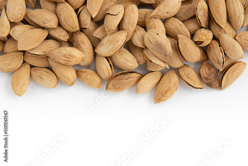 heap of unpeeled almonds isolated on white background