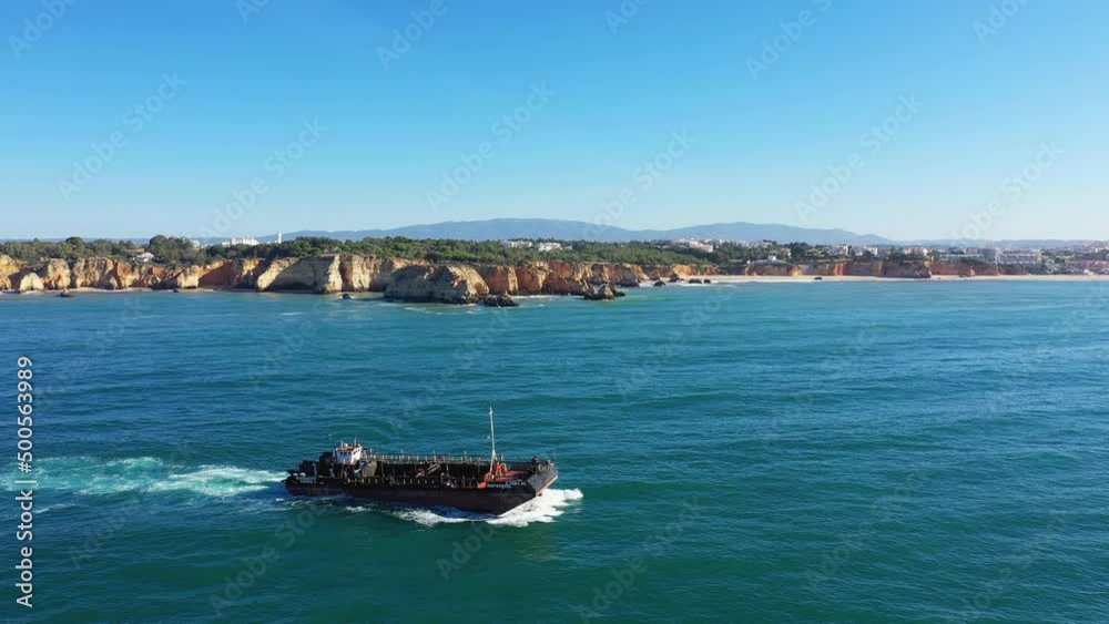 The rich cliffs of the Algarve Coast towards Albufeira , Europe, Portugal, Algarve, towards Albufeira in summer on a sunny day.