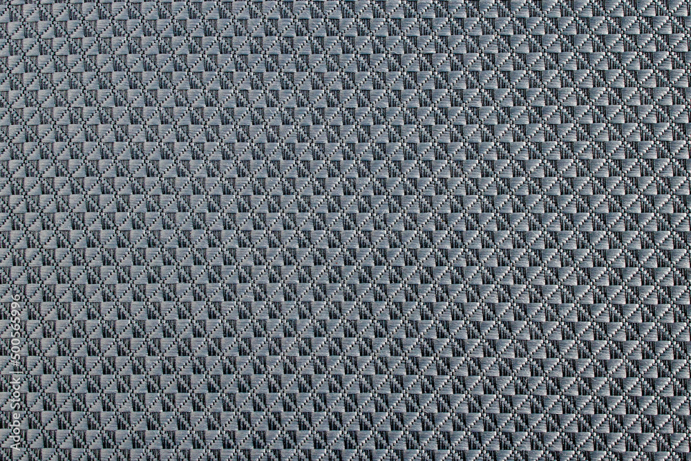 Close up of gray synthetic textured fabric with a rhombus pattern used to make blinds. Template design or polyester material abstract background. Close up of gray synthetic textured fabric with a rhombus pattern used to make blinds. Template design or polyester material abstract background.