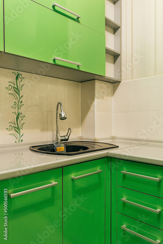 green kitchen sink with faucet