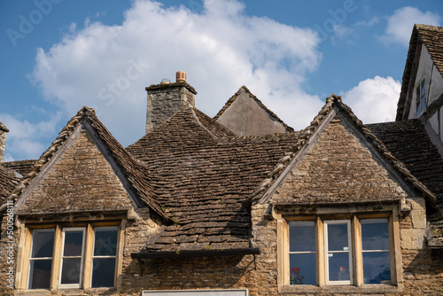 stone mullion windows and stone roof tiles of an 18th Century property in quintessential English village of Lacock Wiltshire