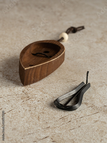 Jew's harp, wooden case, beige background