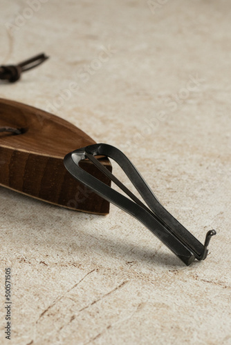 Jew's harp, wooden case, beige background