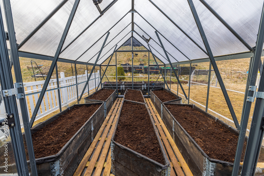 Beautiful view of interior of greenhouse prepared for planting vegetables. Sweden.