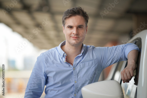 Portrait of a young handsome confident on casual outfit standing outdoor. Free Download Portrait of a young handsome confident on casual outfit standing outdoor. - GFXLoad