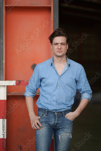 Portrait of a young handsome confident on casual outfit standing outdoor.
