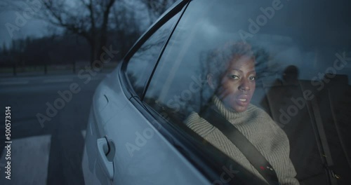 Black Woman on the back seat in a cab taxi or uber photo