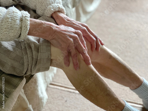 膝を触る高齢女性の手 photo