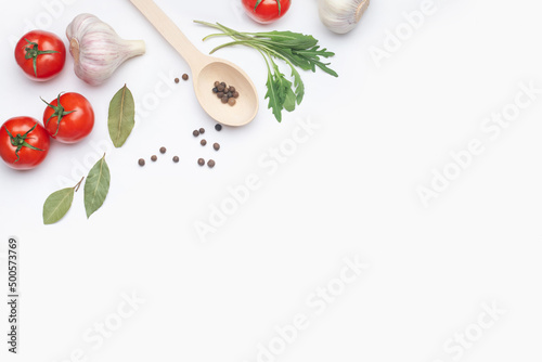 white culinary background with tomatoes, garlic and arugula