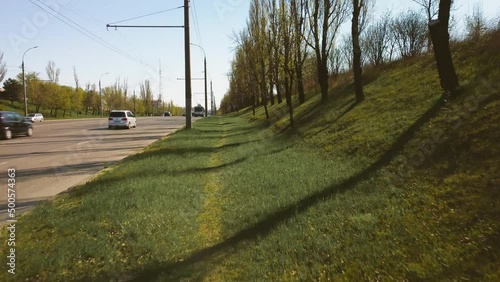 A person in the first person walks along the path along the highway. 4k.