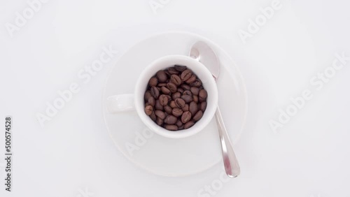 Stop motion animation of a coffee cup being filled with beans turns into espresso