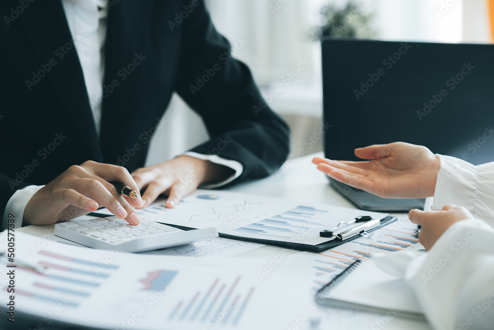 The sales department is having a monthly summary meeting to bring it to the department manager, they are verifying the correctness of the documents that are prepared before bringing in to the manager The sales department is having a monthly summary meeting to bring it to the department manager, they are verifying the correctness of the documents that are prepared before bringing in to the manager