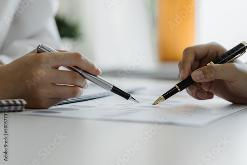 The sales department is having a monthly summary meeting to bring it to the department manager  they are verifying the correctness of the documents that are prepared before bringing in to the manager