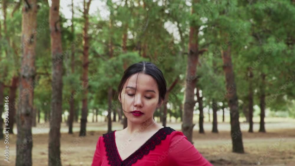 Young asian woman are dancing Traditional Spanish dance in summer forest Young asian woman are dancing Traditional Spanish dance in summer forest