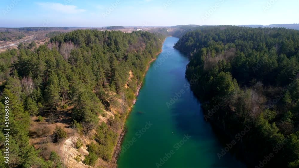 Artificial lake formed after chalk mining in open-pit. Amazing landscape from Drone view of green lake in forest. Green background of the water in forest lake.
Artificial lake formed after chalk mining in open-pit. Amazing landscape from Drone view of green lake in forest. Green background of the water in forest lake.