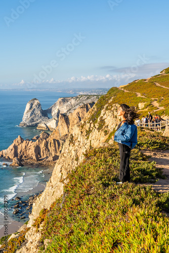 Smiling Young Girl Stands on Edge of Cabo da Roca