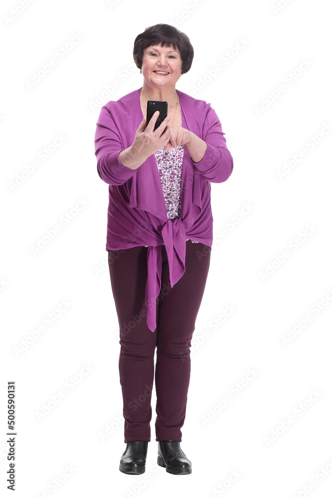 Obraz premium in full growth.casual an elderly woman with a smartphone.