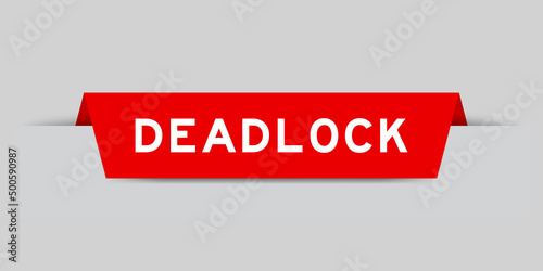 Red color inserted label with word deadlock on gray background