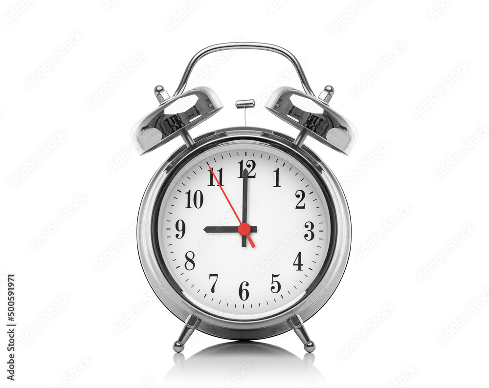 Alarm clock isolated on white background. Nine hours after midnight or noon. Twenty one hours on the clock. Alarm clock isolated on white background. Nine hours after midnight or noon. Twenty one hours on the clock.