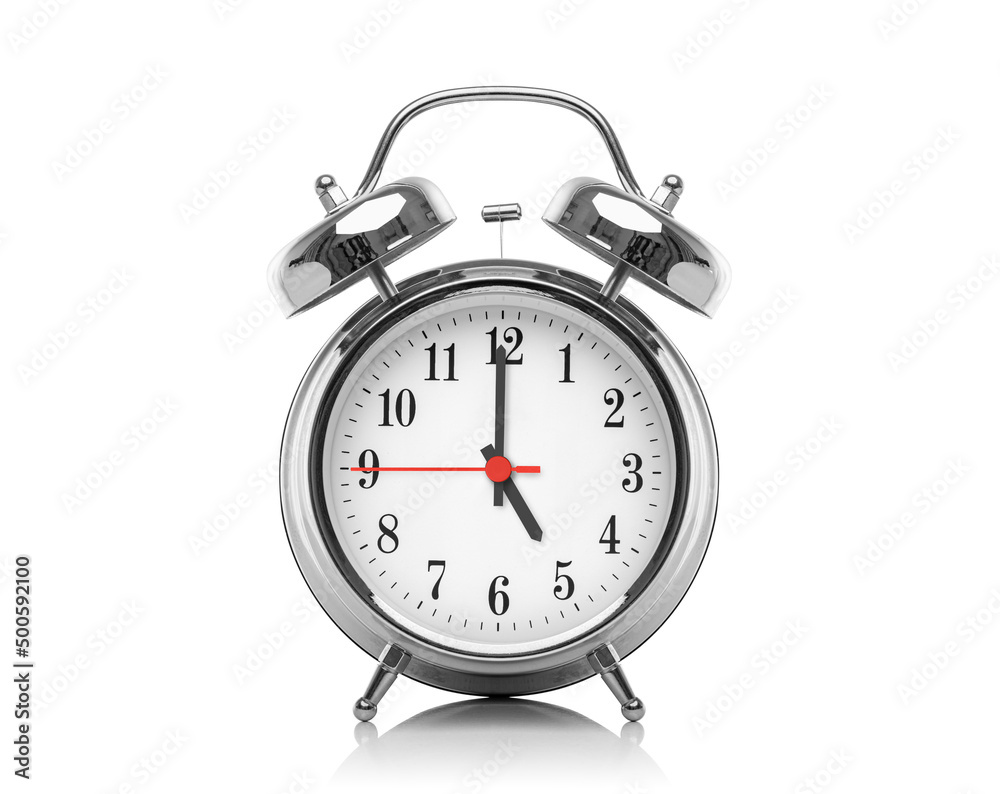 Alarm clock isolated on white background. Five hours after midnight or noon. Seventeen hours on the clock. Alarm clock isolated on white background. Five hours after midnight or noon. Seventeen hours on the clock.