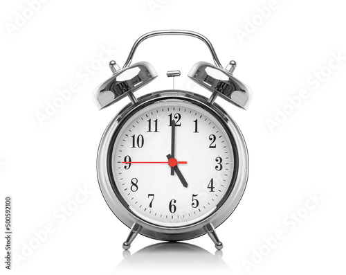 Alarm clock isolated on white background. Five hours after midnight or noon. Seventeen hours on the clock.