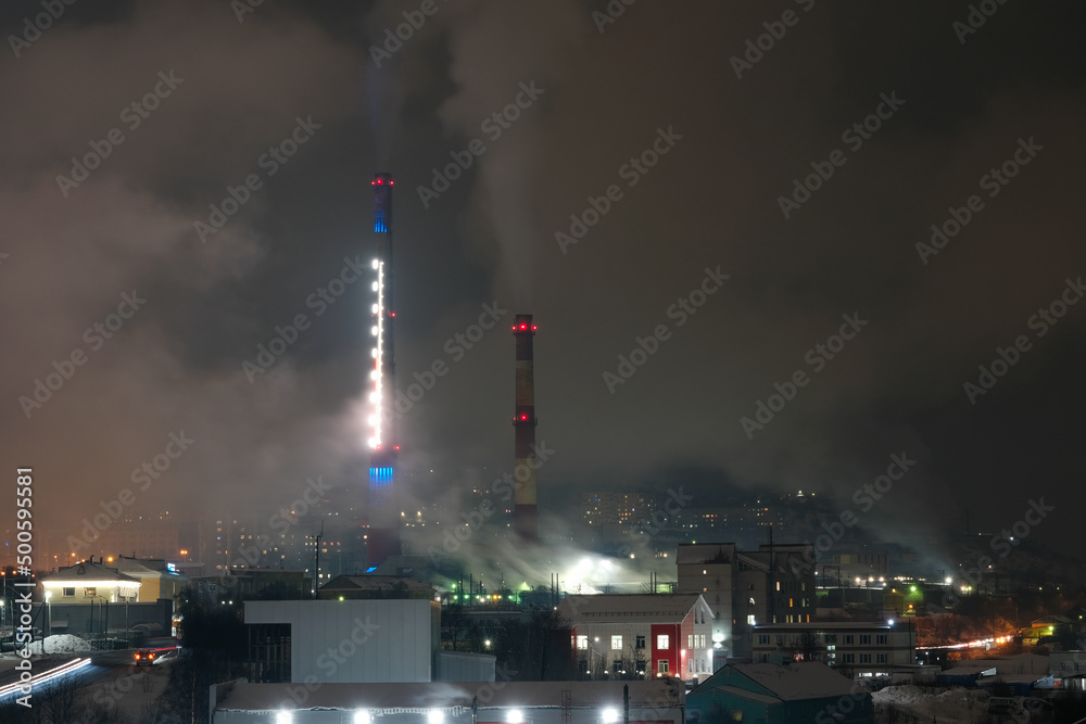 Murmansk cityscape with CHP pipes on polar night. Murmansk Oblast, Russia.