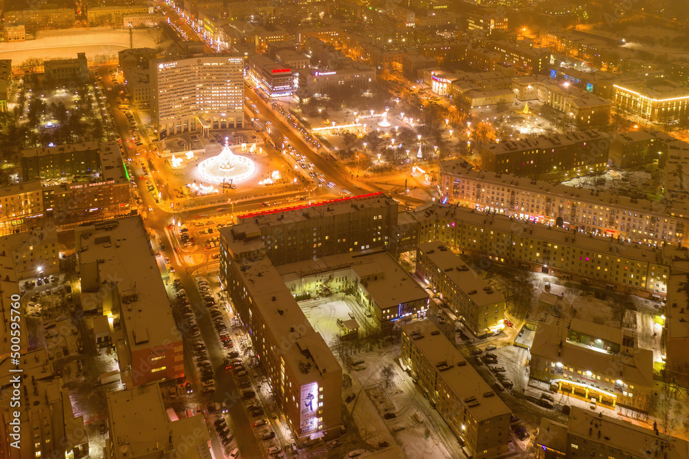 Aerial view of the town and Five Corners square with Christmas tree on polar night. Murmansk, Russia.